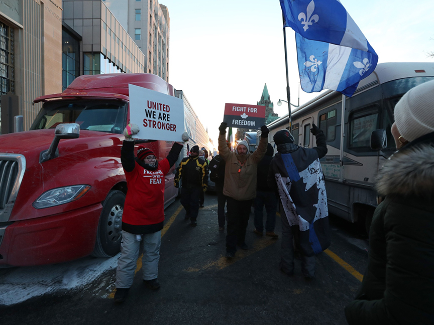 Demonstrators gather as rows of trucks sit parked during a protest against vaccine mandates in Ottawa, Ontario. Photo: Bloomberg.