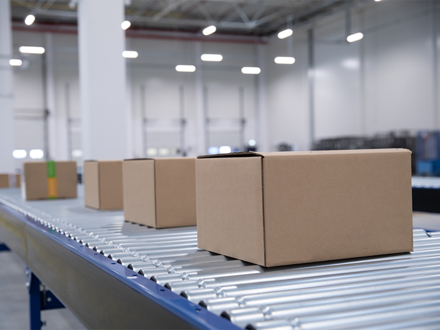 Packages move down a conveyor in a distribution facility. Photo: Getty.