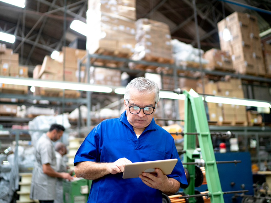 A warehouse worker uses a digital tablet. Photo: Getty.