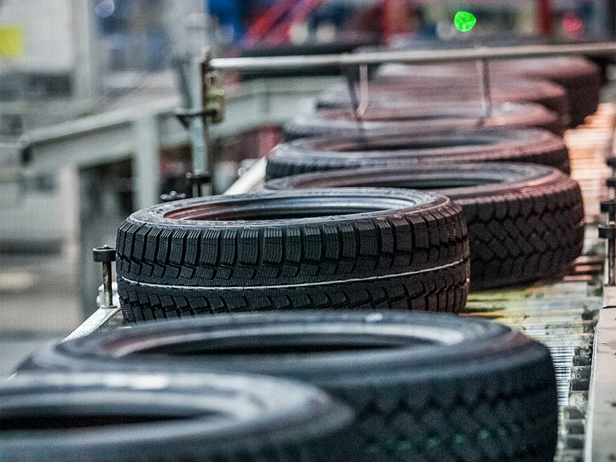 Tires move along a conveyor belt. Photo: Getty.