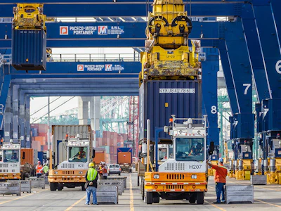 Dockworkers move cargo on a container terminal. Photo: Port of Los Angeles.