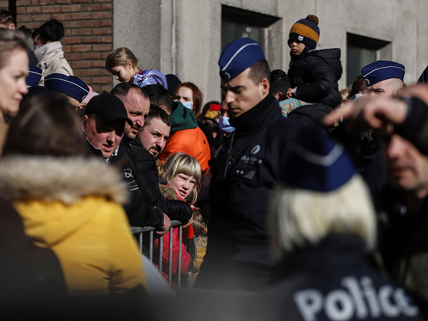 Police officers assist displaced Ukrainians waiting outside a temporary immigration office in Brussels, Belgium. Photo: Bloomberg.