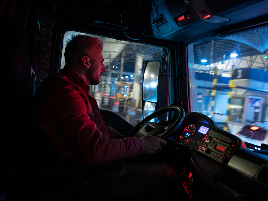 A trucker drives at night. Photo: Getty.
