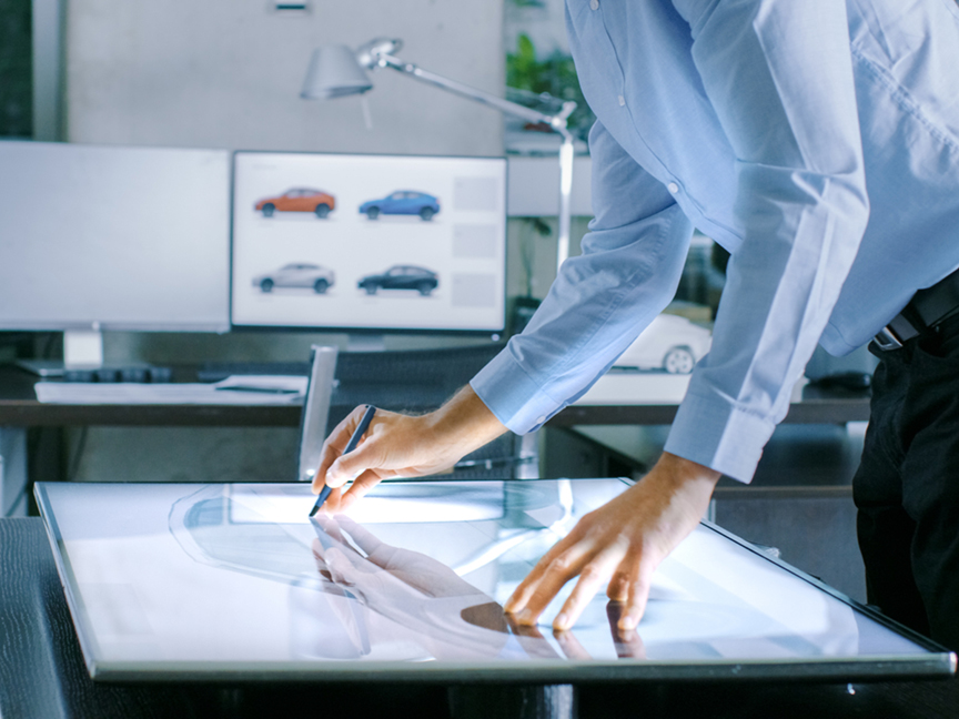 An automotive designer works on a digital tablet. Photo: Shutterstock.