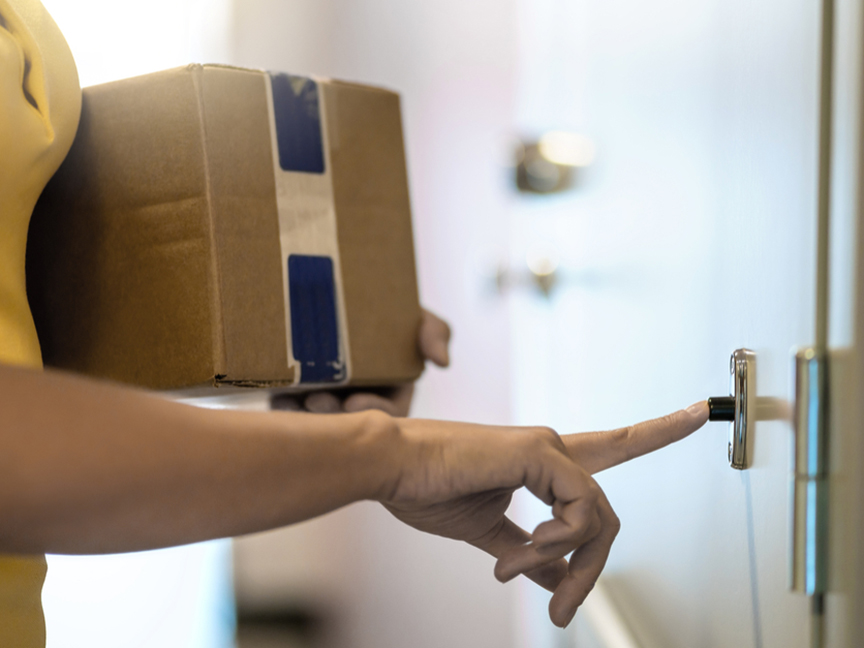 A courier delivers a package. Photo: Shutterstock.