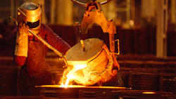 A foundry worker pours molten steel into a casting. Photo: Getty.