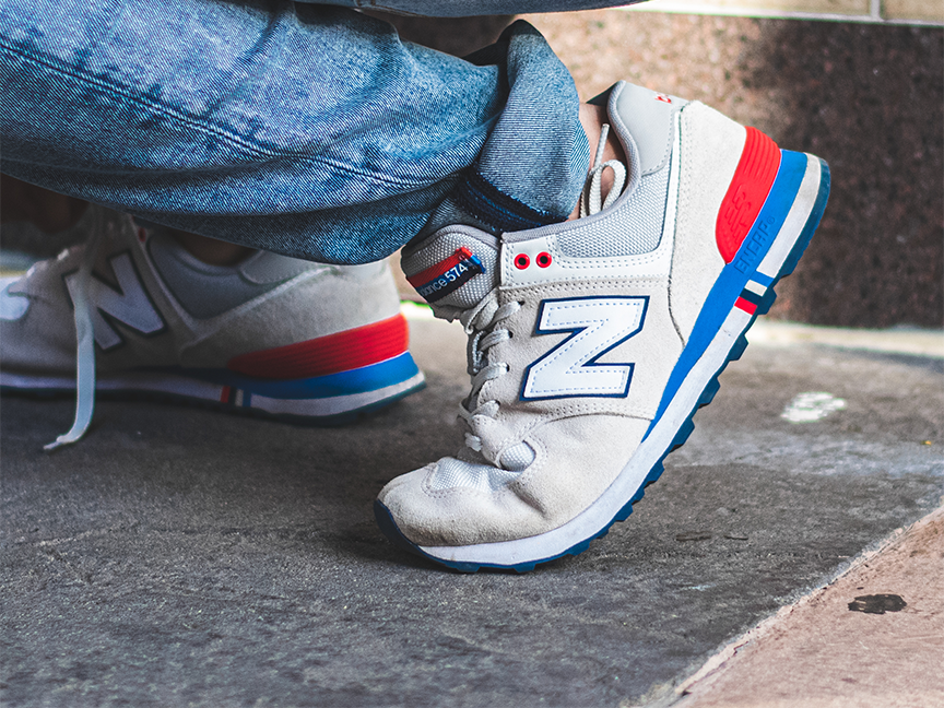 A person wears New Balance brand sneakers. Photo: Malcolm Garret/ Pexels.