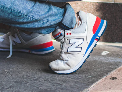 A person wears New Balance brand sneakers. Photo: Malcolm Garret/ Pexels.
