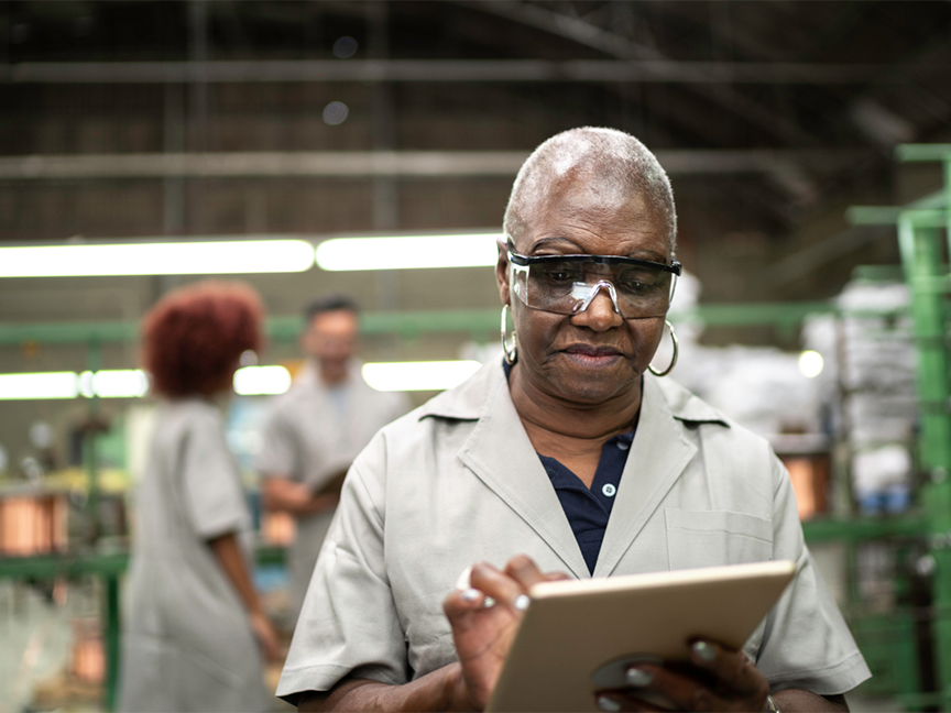 A factory worker uses a digital tablet. Photo: Getty.