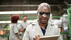 A factory worker uses a digital tablet. Photo: Getty.