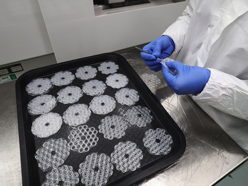 An employee trims silicone bungs, used for in vitro fertilisation (IVF). Photo: Bloomberg.