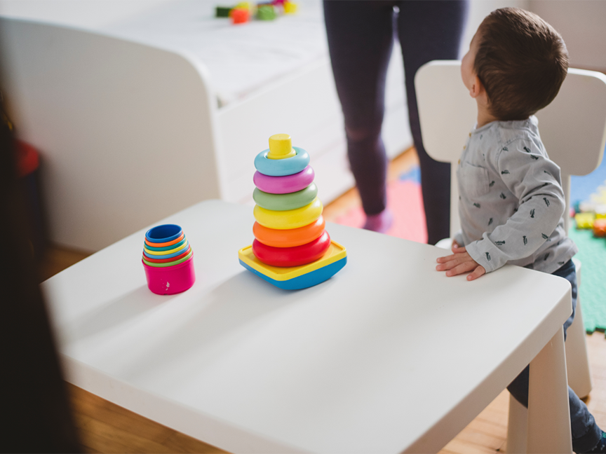 A toddler plays with plastic toys. Photo: Getty.