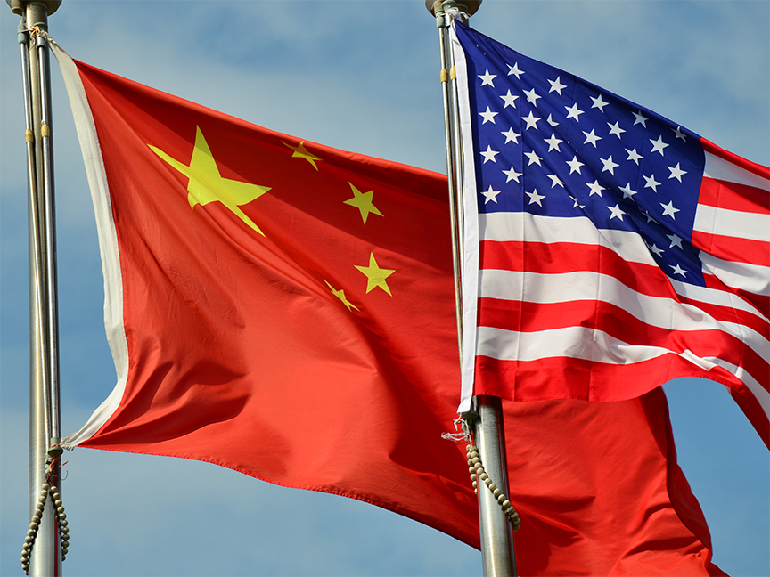 A China and U.S. flag wave side by side in the wind. Photo: Getty.