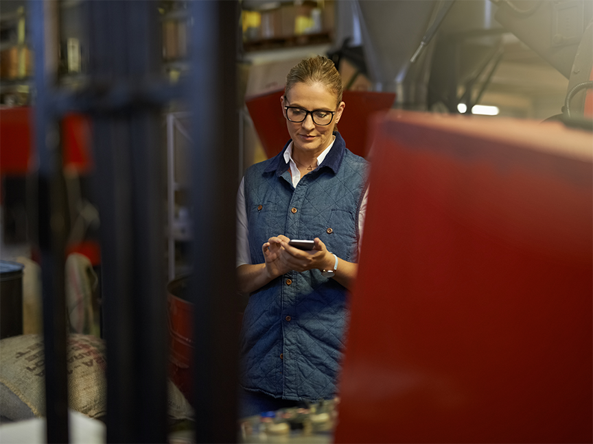 A worker uses a mobile device in a warehouse. Photo: Getty.