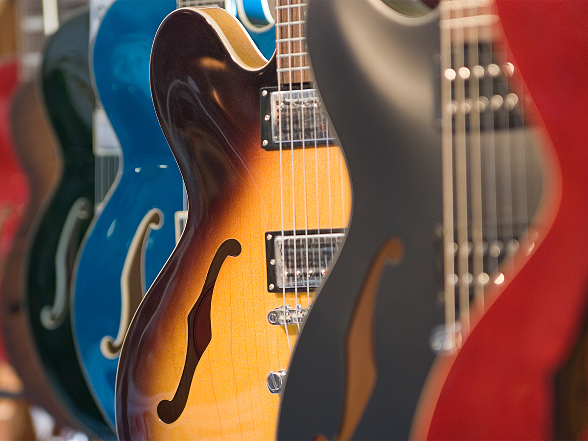 Electric guitars hang in a store. Photo: Getty.