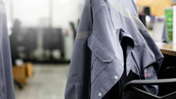 A worker's shirt rests on an empty office chair. Photo: Shutterstock.