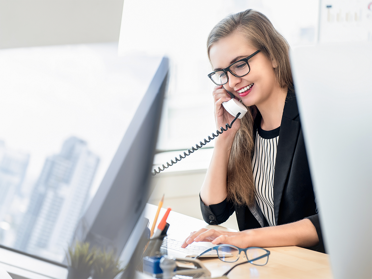 A customer service rep talks on the phone at work. Photo: Getty.