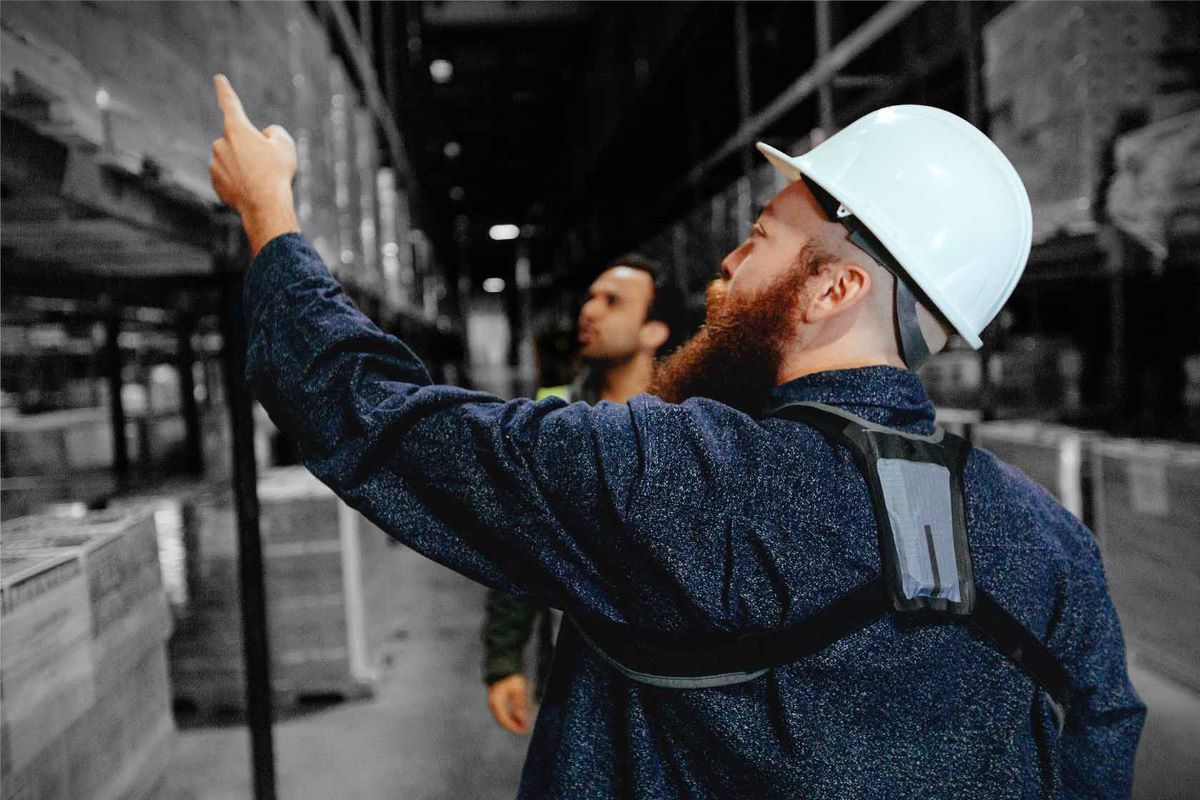 A worker wears a StrongArm sensor while working in a warehouse. Photo: StrongArm