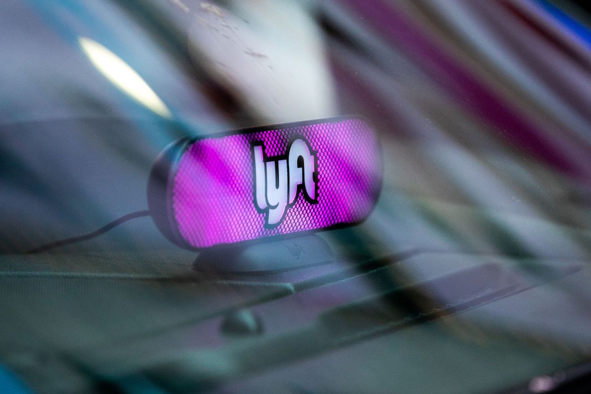 A Lyft Inc. light sits on the dashboard of a vehicle.