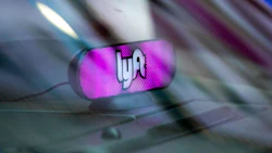 A Lyft Inc. light sits on the dashboard of a vehicle.