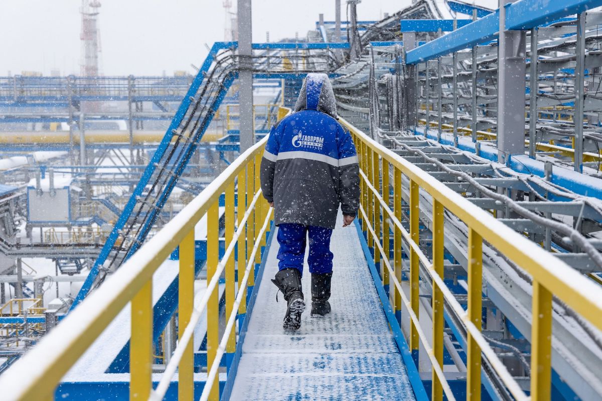 A worker walks along an access platform at the Comprehensive Gas Treatment Unit in Russia.