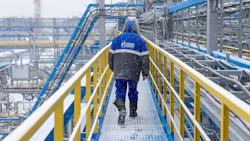 A worker walks along an access platform at the Comprehensive Gas Treatment Unit in Russia.