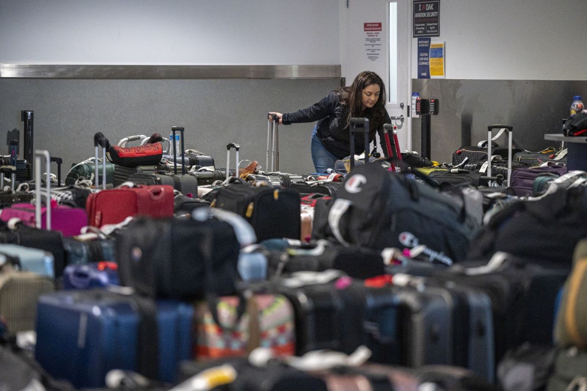 A traveler looks for luggage in the Southwest Airlines baggage claim area at Oakland International Airport in Oakland, California, on Dec. 28, 2022. Photographer: David Paul Morris/Bloomberg