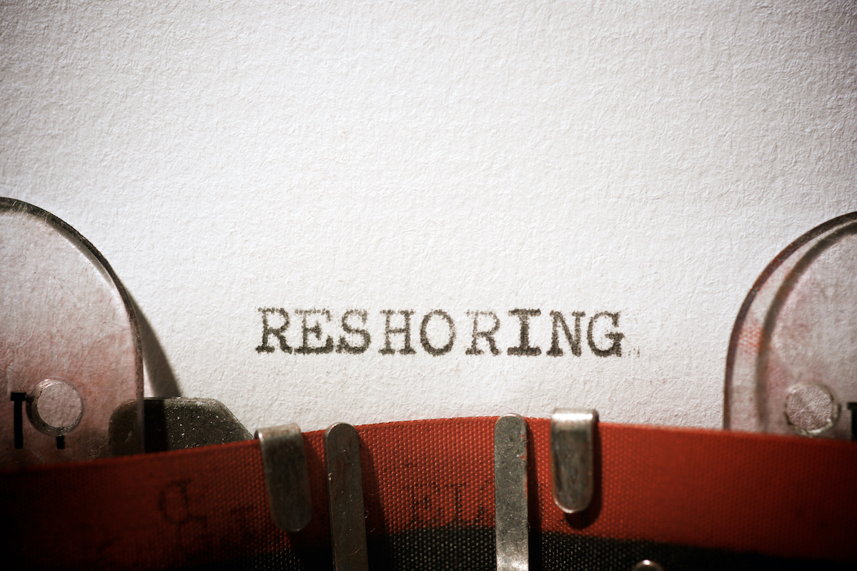 The word 'RESHORING' is written on a typewriter. Photo: iStock.com/pedrosala