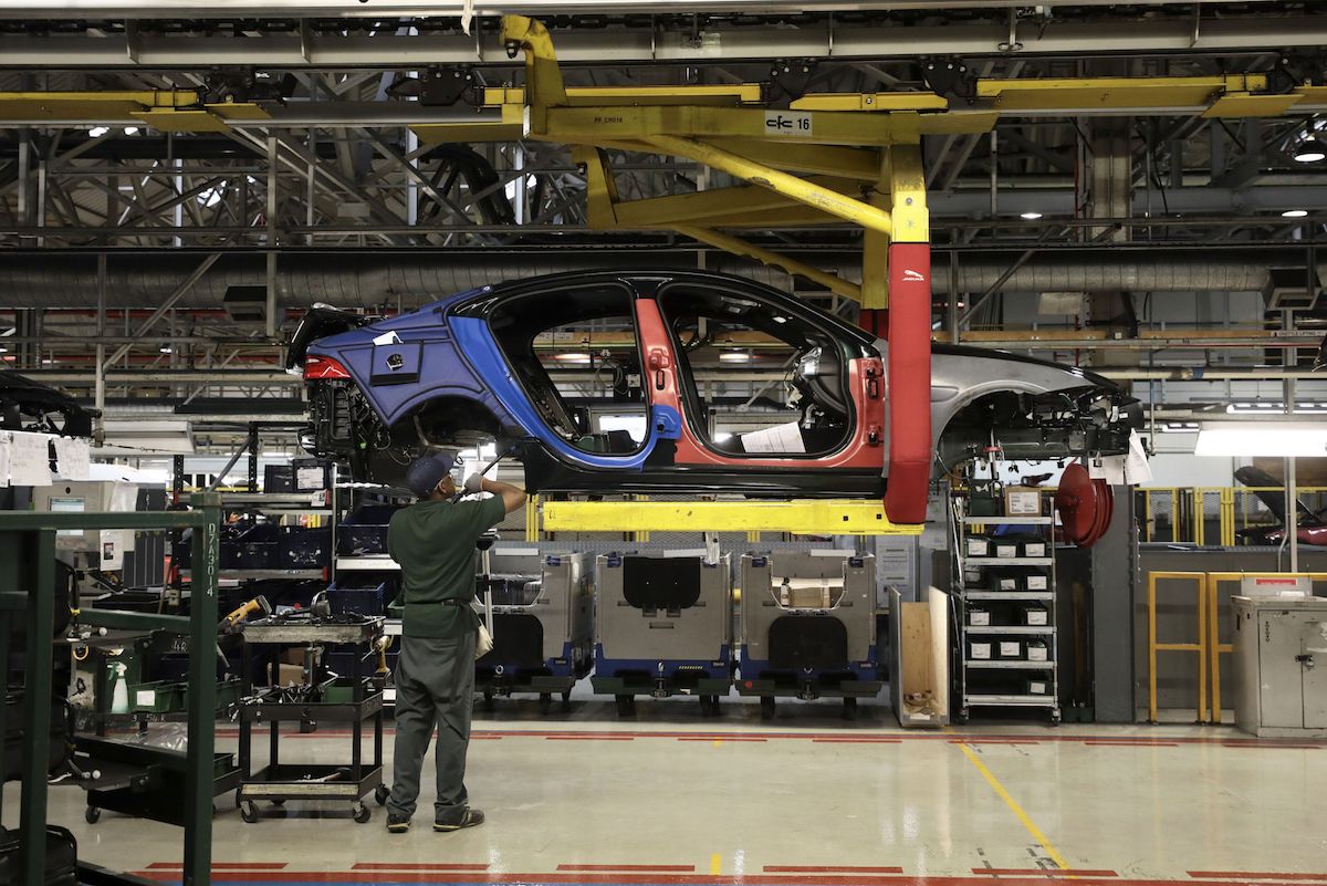 An employee works on a Jaguar XJ automobile on the production line at Tata Motors Ltd.'s Jaguar assembly plant in Castle Bromwich, U.K., on Thurs., March 16, 2017. Photo: Bloomberg