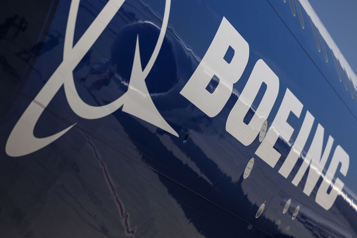 A logo on the body of a Boeing passenger aircraft.