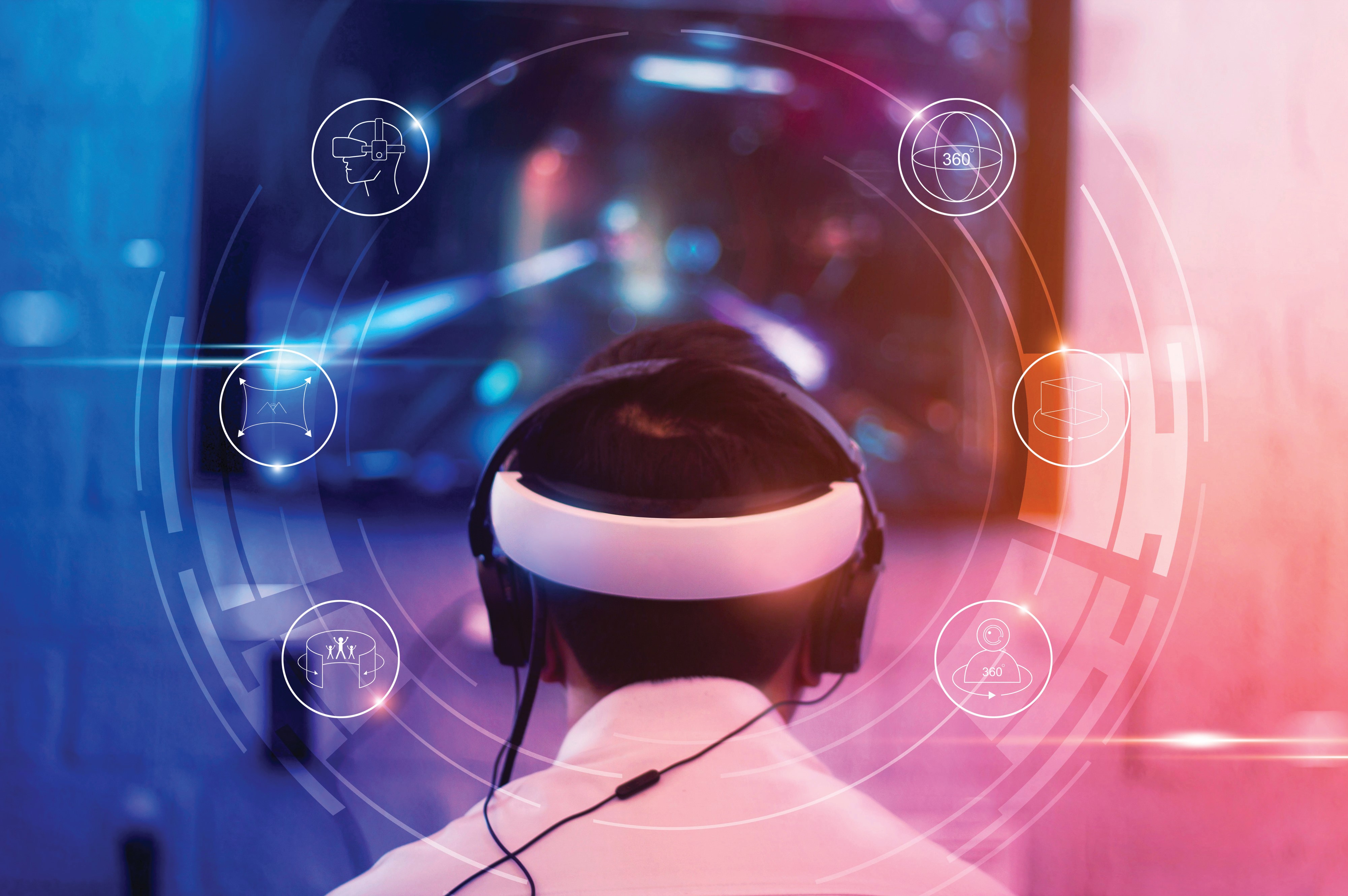 Young gamer wearing VR goggles and headset with icon VR playing and winning driver and shooter online video game on his personal computer in the room lit by neon lights, eSport network online.