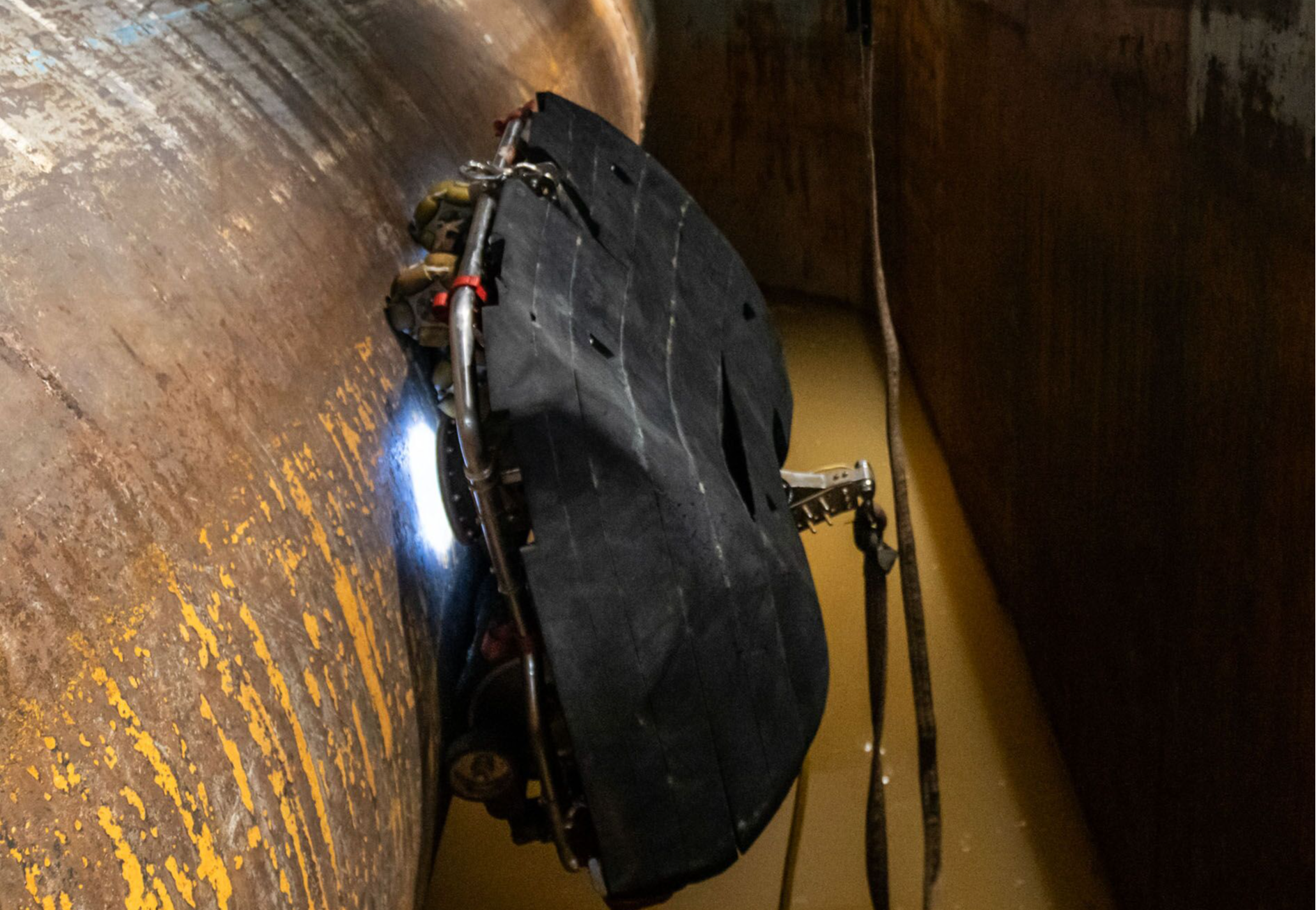 A demo at the Neptune Robotics facility in Shenzhen shows one of the company's robots in a room built to simulate the curvature of a ship...s hull and muddy water conditions.