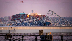 A U.S. Coast Guard helicopter flies over the Dali container vessel after it struck the Francis Scott Key Bridge in Baltimore, Maryland, U.S., on March 26. Photo: Bloomberg