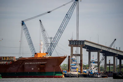 The bulk carrier cargo ship, Saimaagracht, sails past the cargo ship Dali and the collapsed Francis Scott Key Bridge in Baltimore Maryland on April 25. Photographer: Andrew Harnik/Getty Images