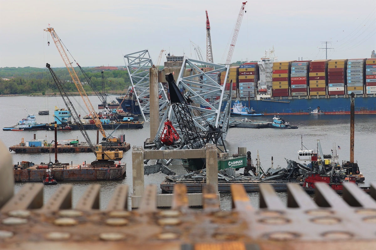 Salvors continue to remove debris from the wreckage site of the Francis Scott Key Bridge collapse as seen from the edge of the remaining bridge that still stands April 17. Debris and wreckage removal is on-going in support of a top priority to safely and efficiently open the Fort McHenry channel. Photo: U.S. Army Corps of Engineers, Baltimore District