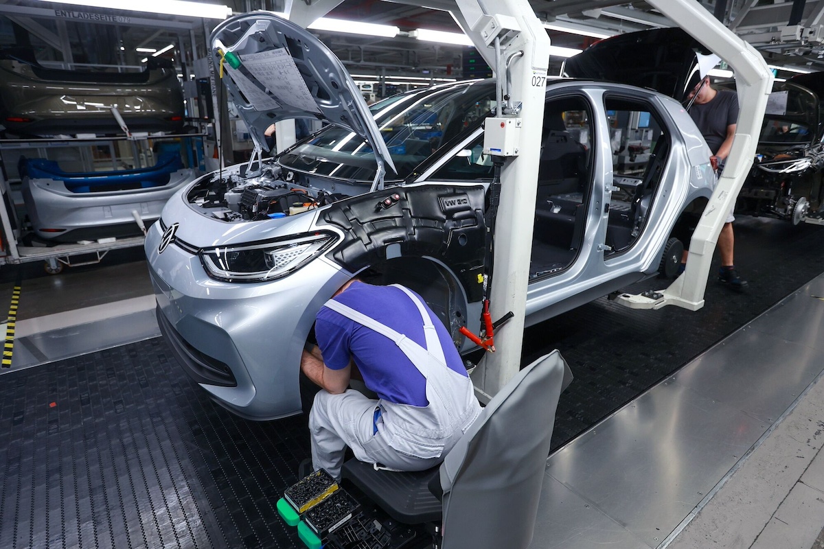 Employees fit a bumper to a Volkswagen AG VW ID.3 car on the assembly line at the Volkswagen Sachsen GmbH plant in Zwickau, Germany, on Wednesday, May 24, 2023. Auto sales in Europe rose in April for a ninth month as supply chains improved and carmakers worked through backlogs of orders. Photographer: Krisztian Bocsi/Bloomberg
