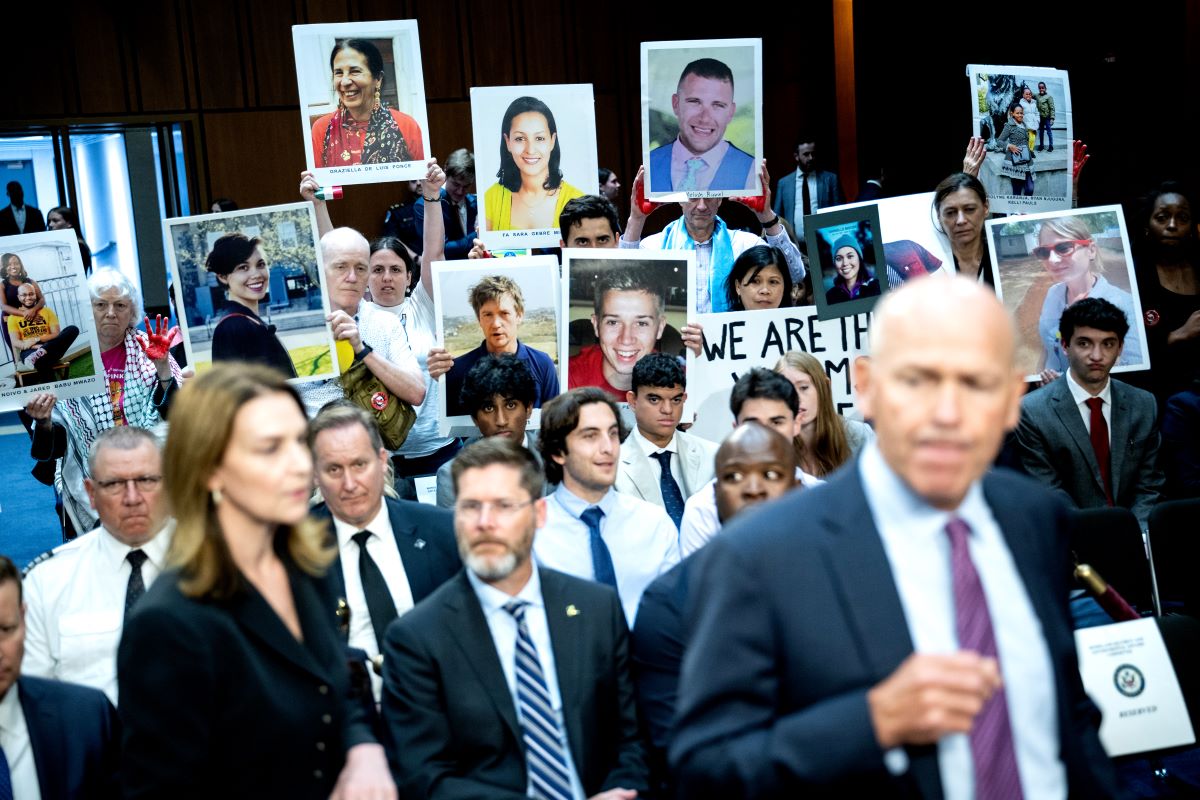 Relatives of Boeing airplane crash victims hold images as Boeing’s Dave Calhoun arrives at a hearing in Washington, D.C., on June 18. Photographer: Graeme Sloan/Bloomberg