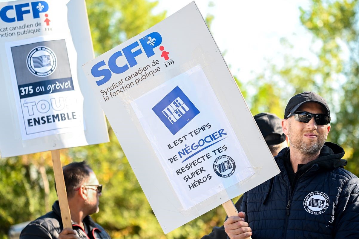 Workers picket outside the Termont Terminal Inc. Maisonneuve terminal during a dockworkers' strike in Montreal. Photographer: Graham Hughes/Bloomberg