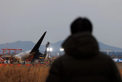 The tail of Jeju Air plane at the site of a plane fire at Muan International Airport in Muan County, South Korea, on Dec. 29. Photographer: SeongJoon Cho/Bloomberg