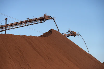 Iron ore falls onto stockpiles at the Fortescue Metals Cloudbreak mine in Western Australia. Photo: Carla Gottgens/Bloomberg