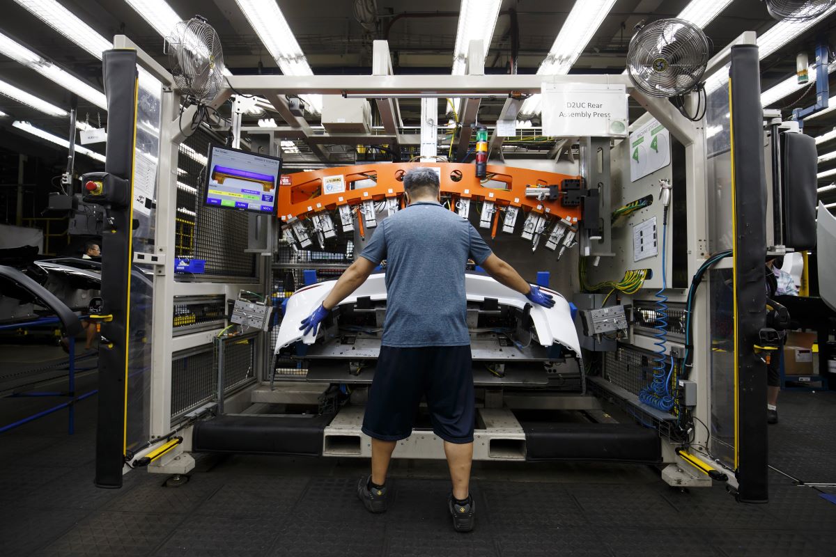 An employee assembles a rear bumper at an auto parts manufacturing facility in Guelph, Ontario. Photographer: Cole Burston/Bloomberg