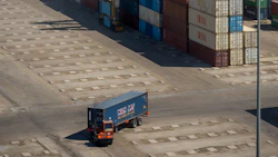 A truck carries a shipping container through a storage area at Bandar Imam Khomeini (BIK) port in Bandar Imam Khomeini, Iran. Photographer: Ali Mohammadi/Bloomberg