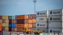 A truck drives past shipping containers at the Port of Montreal. Photographer: Andrej Ivanov/Bloomberg