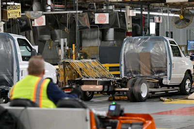 Commercial trucks wait to go through error inspection prior to the final stages of the assembly process at Ford's Ohio Assembly Plant in Sheffield Lake, Ohio. Photographer: Dustin Franz/Bloomberg