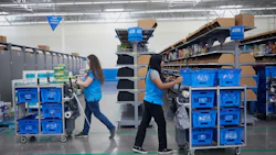 Employees gather online orders at a Walmart market fulfillment center in Grapevine, Texas. Photographer: Dylan Hollingsworth/Bloomberg