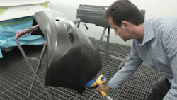 Roger Turmel of Auto Quip uses the Stat Gun to blow off a bumper. Reducing static decreases polishing time.