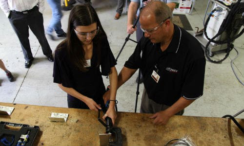 Richard Perry of Chief Automotive (right) helps a journalist set up equipment at a recent media event. Collision Repair magazine was the only Canadian publication present.