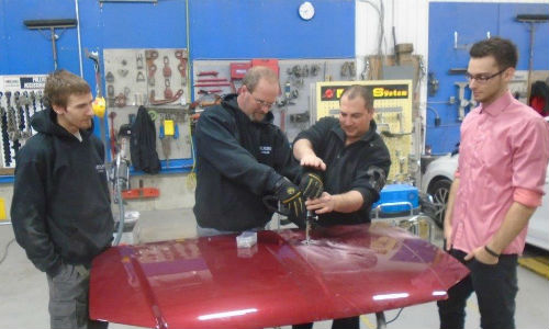 Errol Cowan of Titanium Tools & Equipment (centre) demos the Miracle System for some of the staff at CSN-Carlaw Collision.
