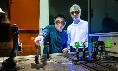 Adrian Sabau and Jian Chen work with a laser to prepare the surface of carbon fibre composites and aluminum to create superior bonds that can absorb 200 percent more energy than conventional bonds.