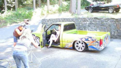 A model poses for a calendar shoot with a mini truck Wes Mclean worked on. McLean was a rising star in mini truck when he was involved in a collision in 2012.